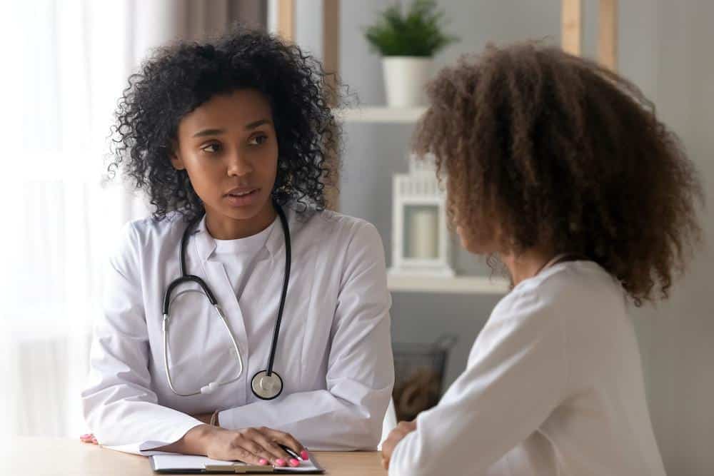Depressed teen talks to mental health professional